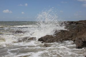 The impressive sea crashing on the rocks