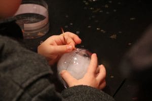 Little hands making a Christmas Ornament